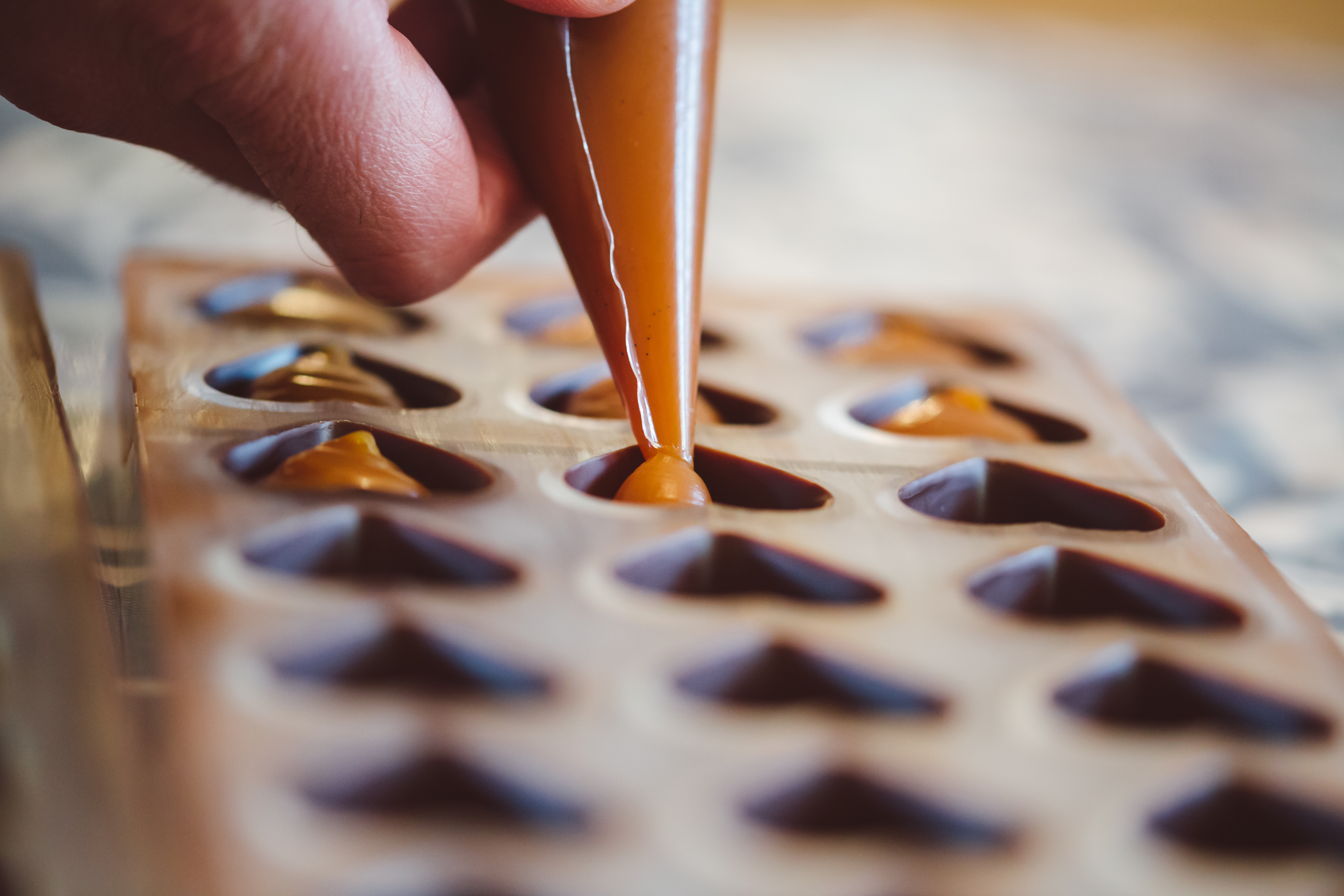 Piping chocolate into molds